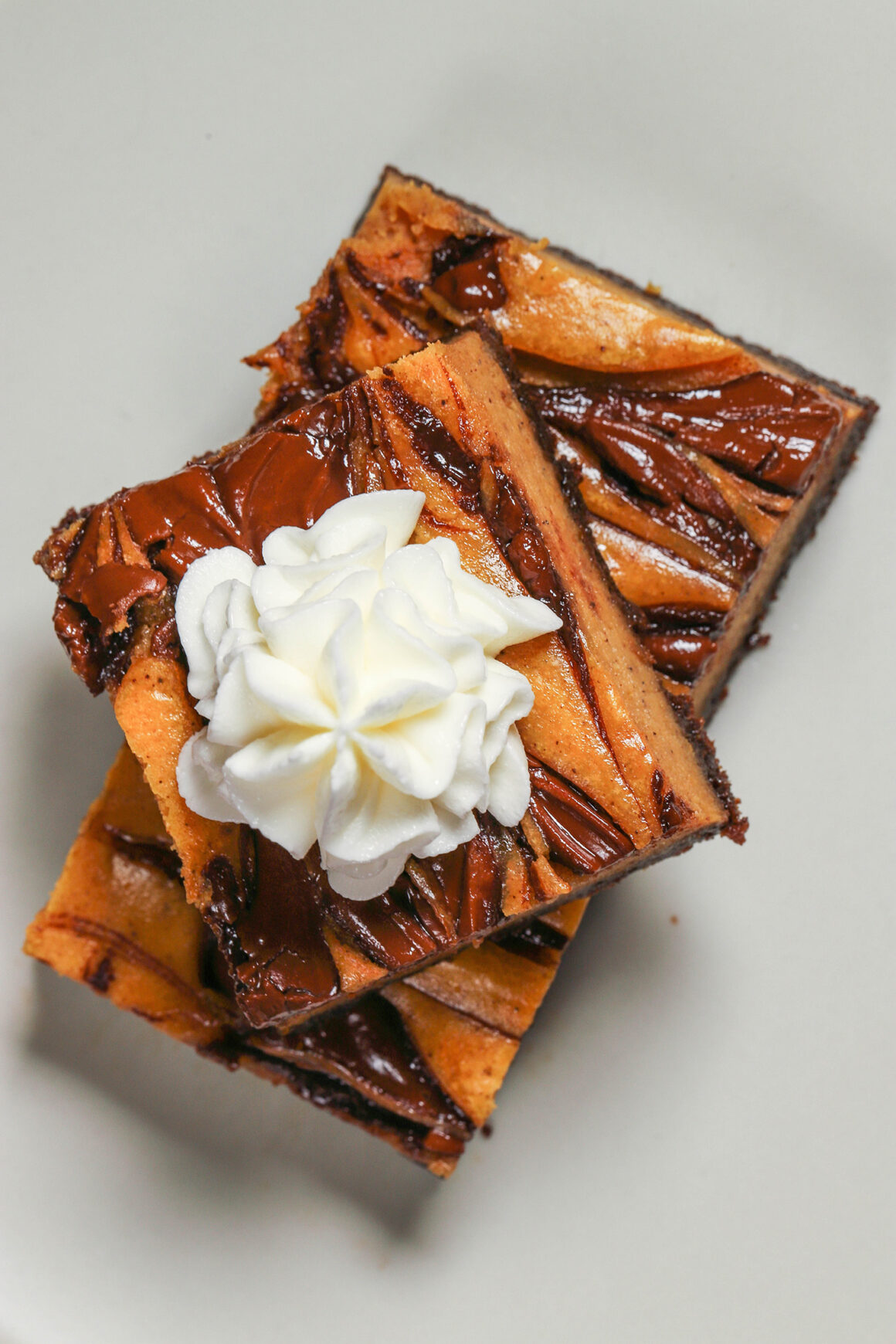 Pumpkin Cheesecake Bars with Nutella and Whipped Cream