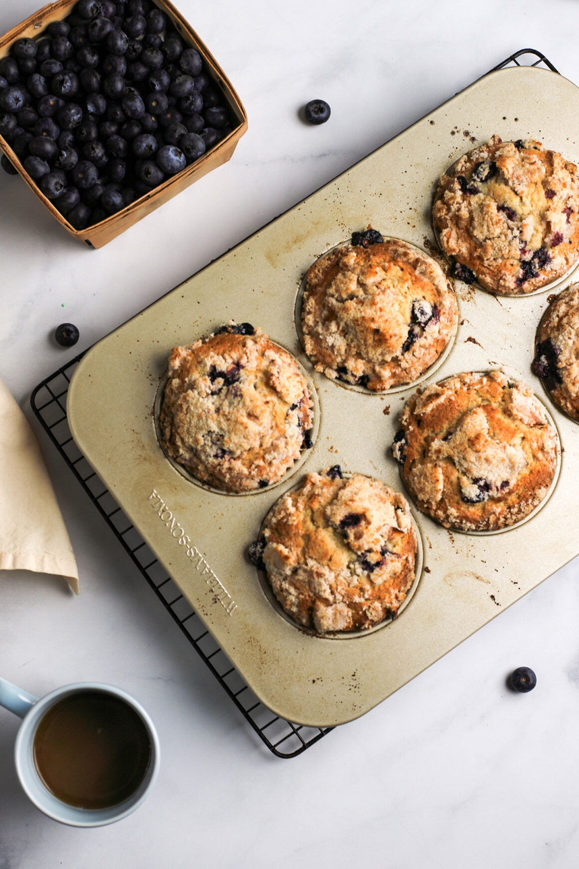 peach blueberry muffins in muffin tin
