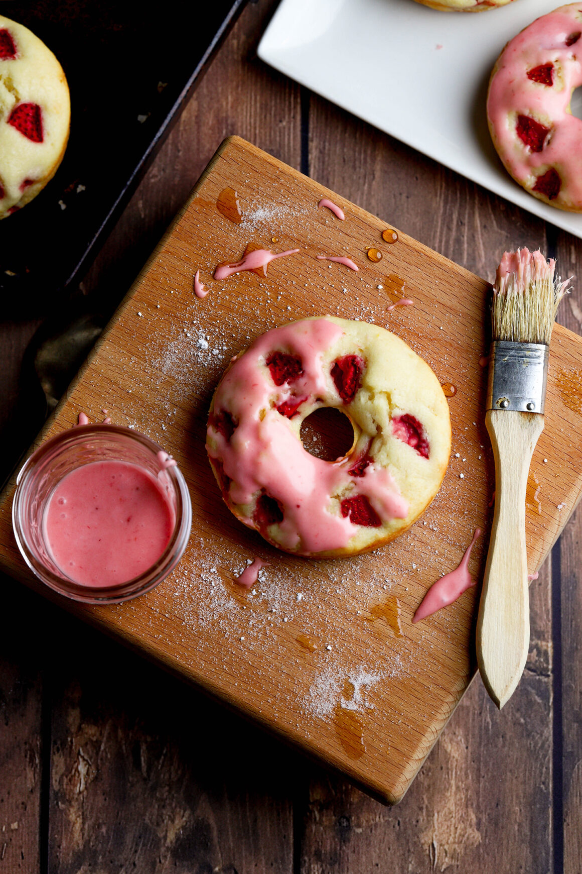 glazing strawberry doughnuts
